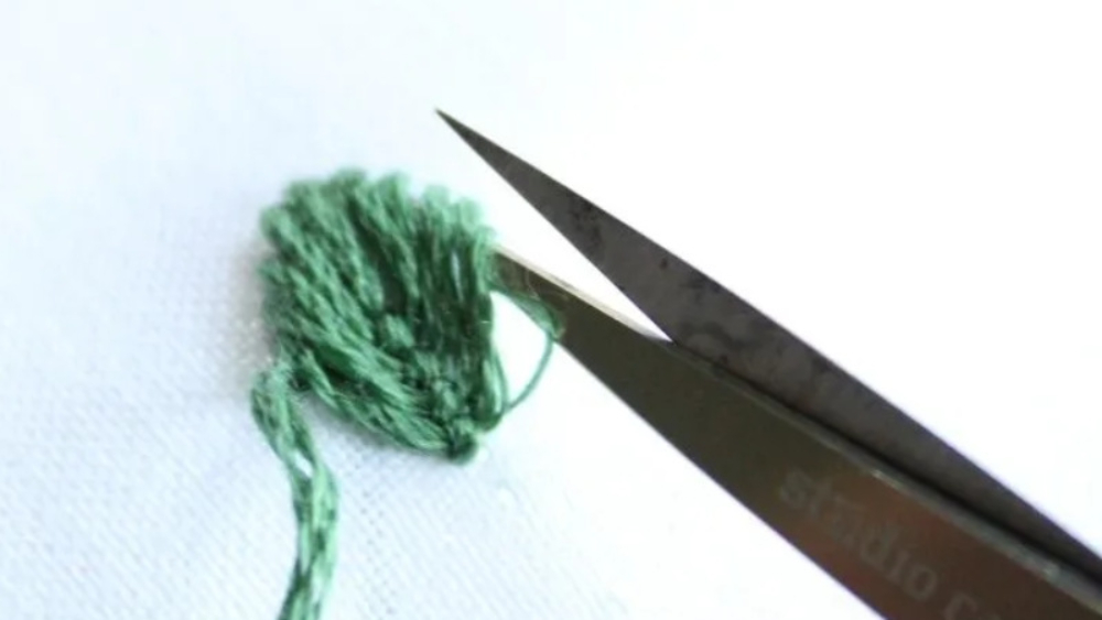 remove embroidery with trimming scissors